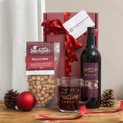 Warm up those winter nights with this festive mulled wine, gourmet popcorn, and glass mug gift set — a perfect Christmas treat for someone special. Mulled Wine Night In Gift Set